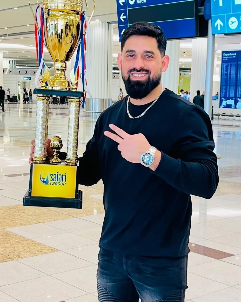 Mohammad Chowdhury holding the Safari T20 Cup trophy