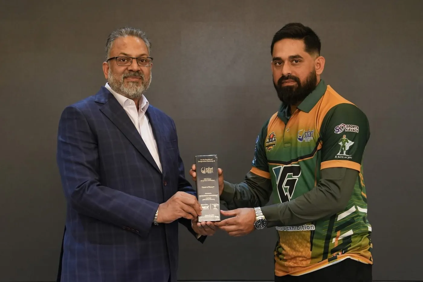 UK Bangla Tigers player receiving an award plaque